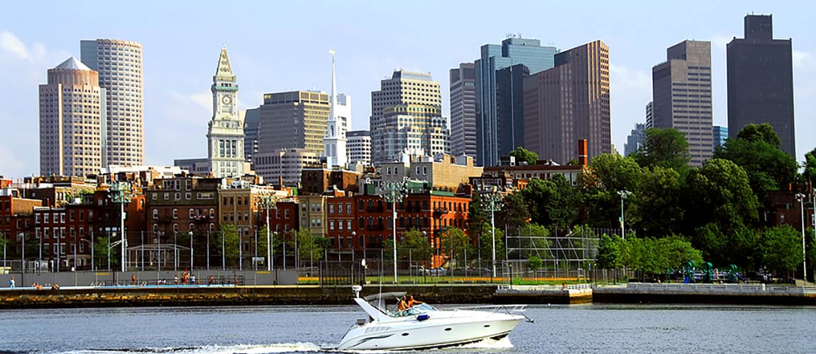 Couple sitting together on couch looking at laptop
