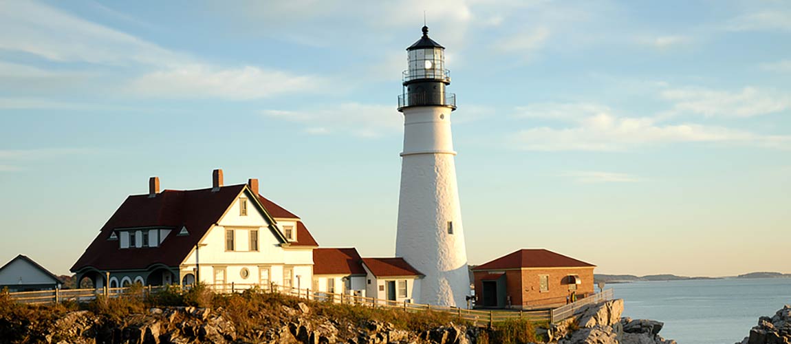 Couple sitting together on couch looking at laptop